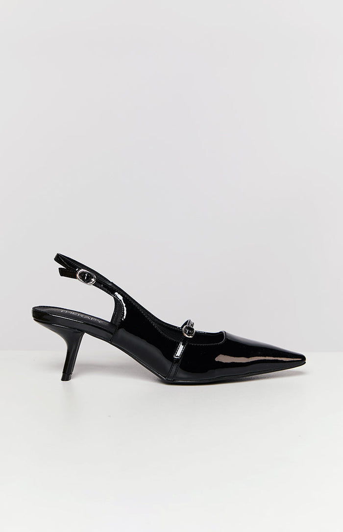 Side view of a black patent slingback heel with a pointed toe, kitten heel, and buckled vamp strap