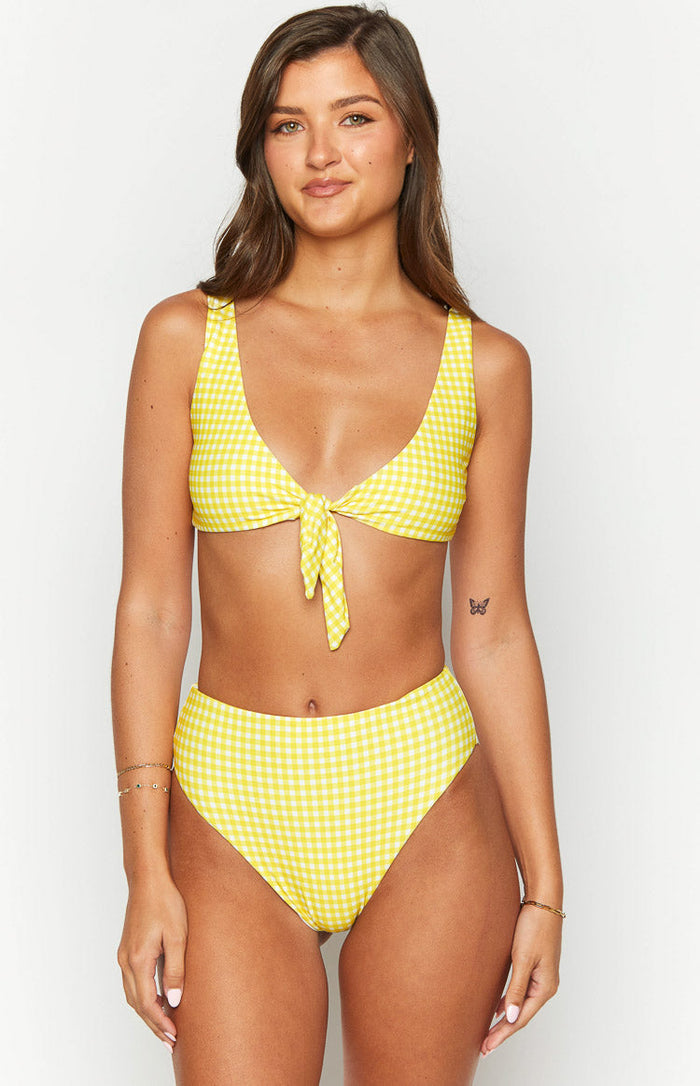 Front view of a yellow gingham bikini top with a tie-front detail and scoop neckline