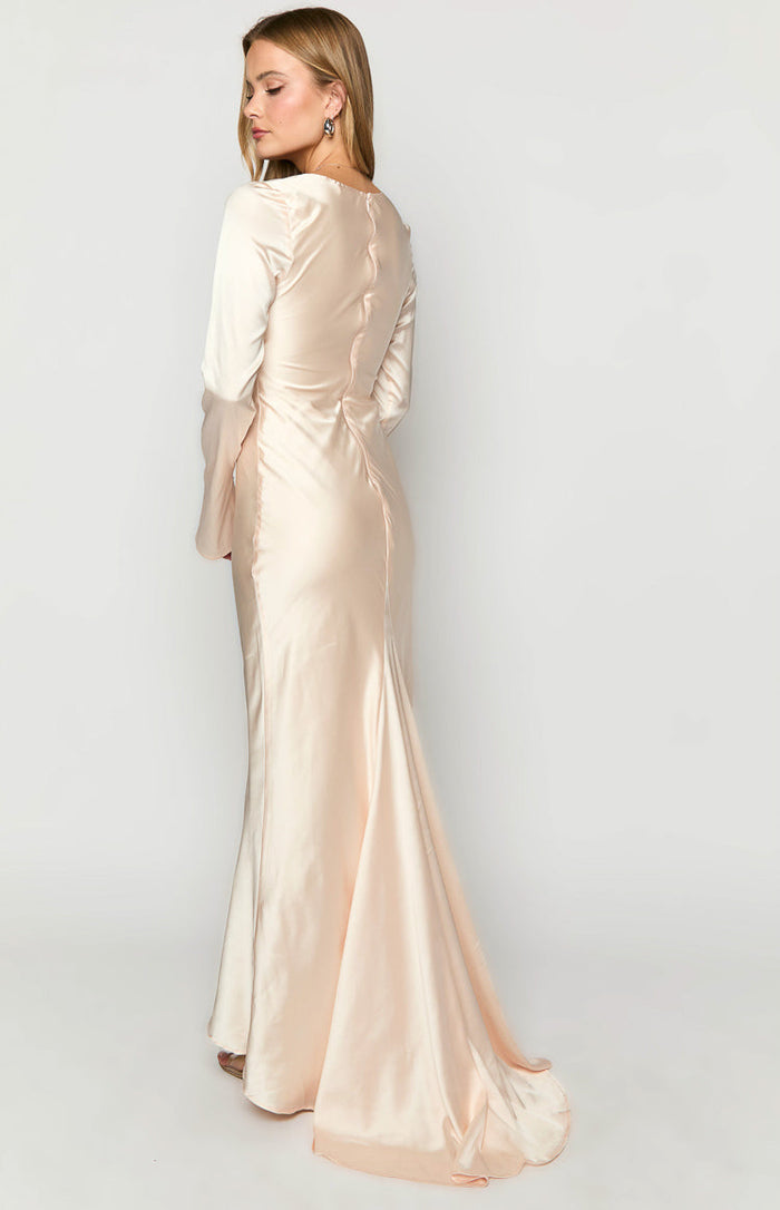 Rear view of a cream satin long sleeve maxi dress with a fitted bodice and flowing train
