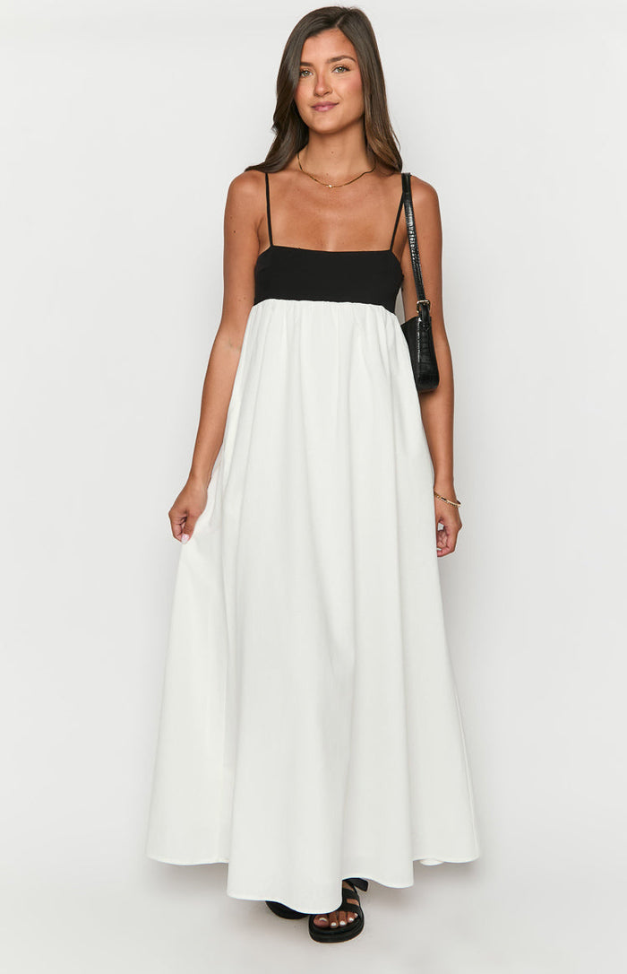 Front view of a black and white contrast maxi dress with a square neckline and thin spaghetti straps