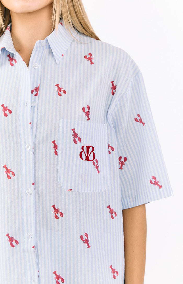 Close-up of the blue striped pajama shirt with red lobster print, showing the chest pocket with red BB logo and short sleeve