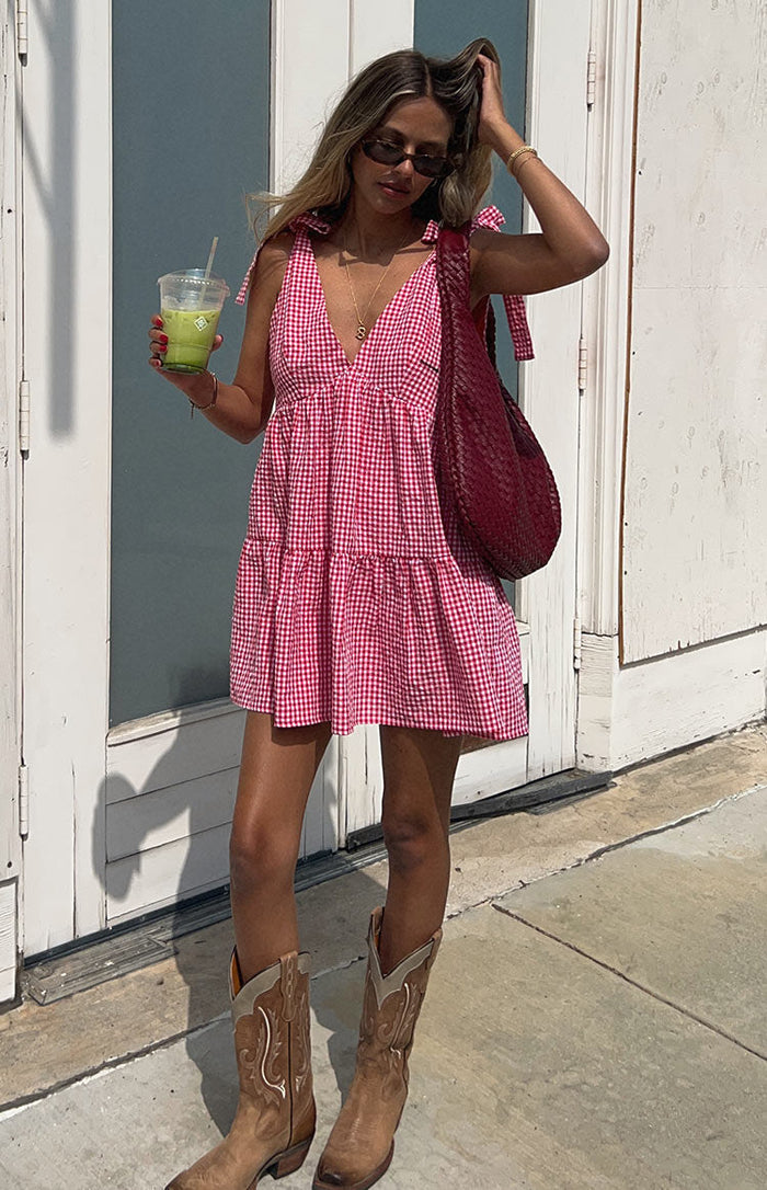 Beginning Boutique Angel Girl Red Gingham Mini Dress red gingham V-neck mini dress with tie shoulders and a tiered babydoll skirt