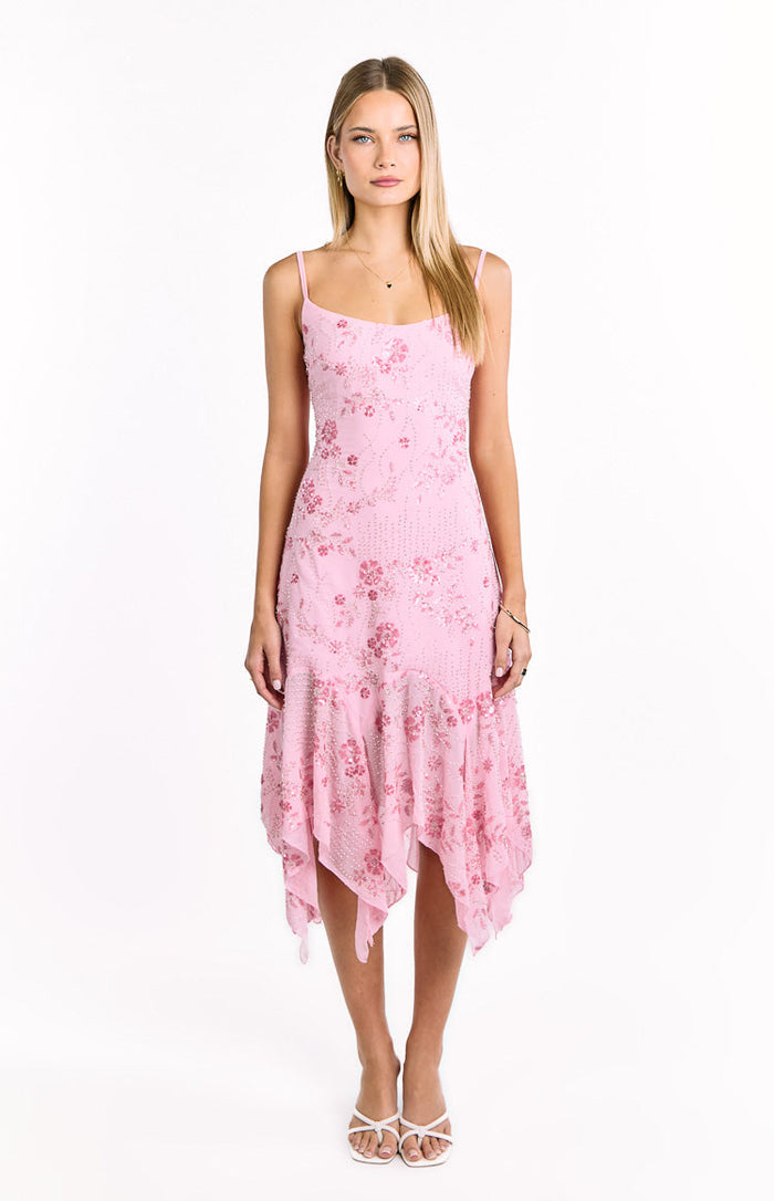 Front view of a pink sequin midi dress with a floral pattern, spaghetti straps, and a handkerchief hem