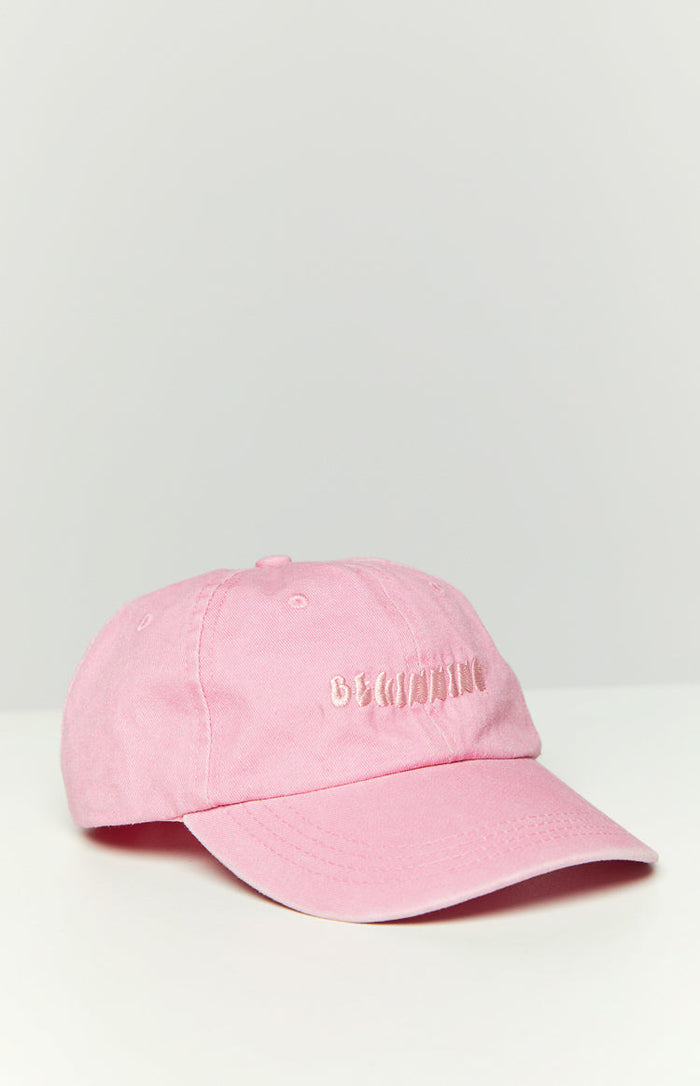 Pink washed cap with embroidered "BEGINNING" text on the front