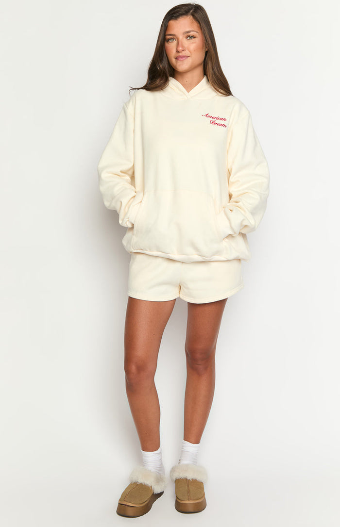 Cream oversized hoodie with red "American Dream" embroidery and a front kangaroo pocket