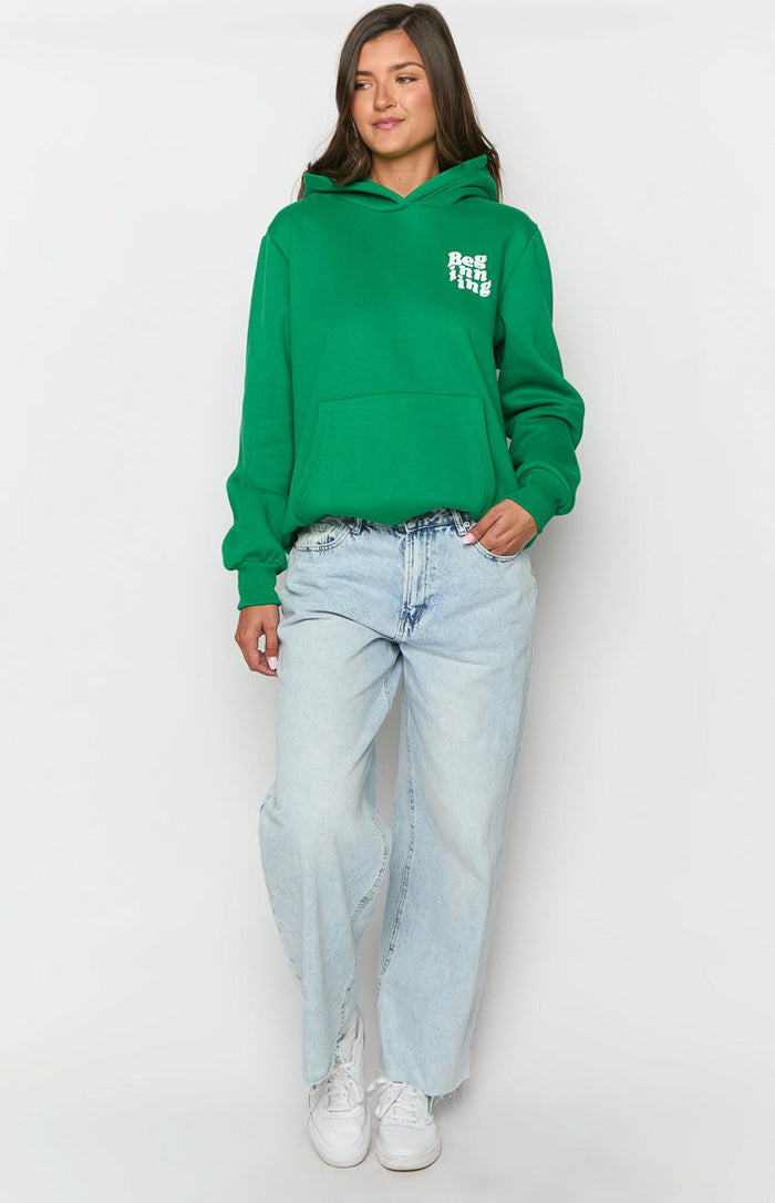 Green oversized hoodie with a kangaroo pocket, white chest text, and bubble long sleeves