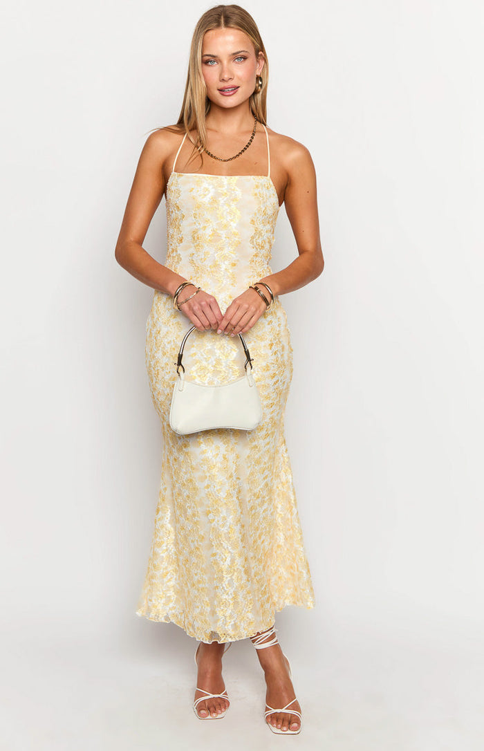 Yellow lace maxi dress with a square neckline, delicate spaghetti straps, and a subtle mermaid-style flare