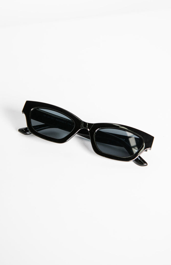 Angled view of black slimline sunglasses with dark rectangular lenses and subtle upturned outer corners