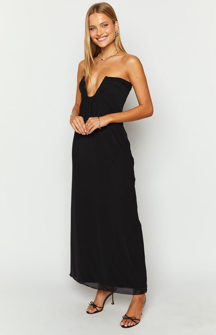 Black strapless maxi dress with a deep V-neckline and a flowing skirt with a sheer hem