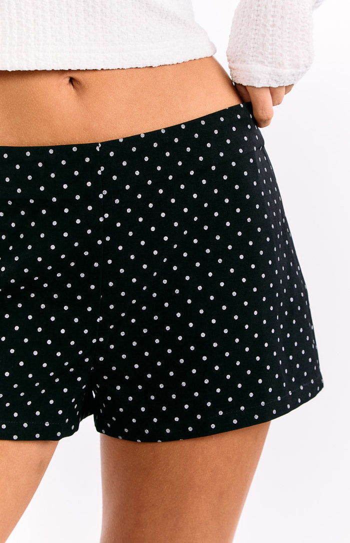 Close-up of the black polka dot shorts showing the fitted waistband and small white dots