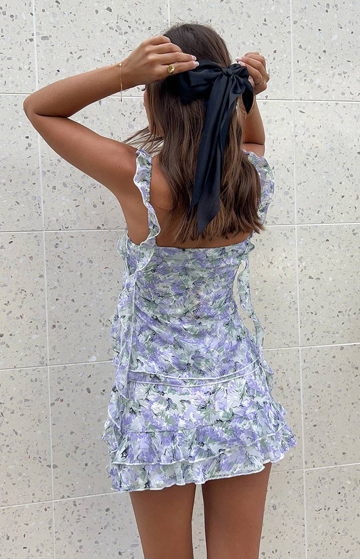 Rear view of the purple floral chiffon mini skirt with ruffled tiers and side tie details