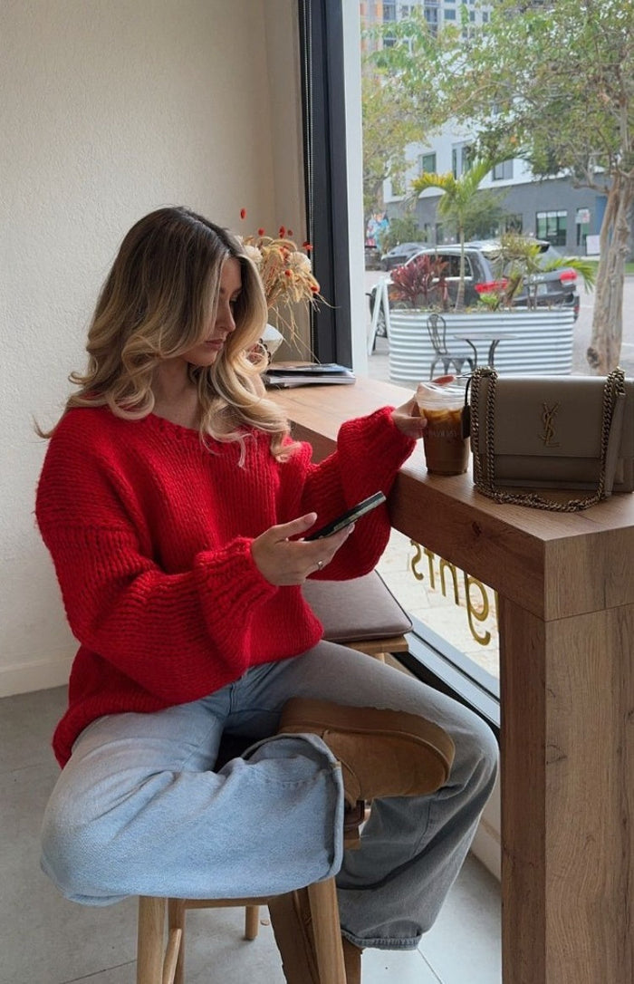 Relaxed fit red chunky knit sweater with a wide V-neck and long voluminous sleeves