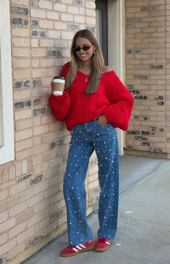 Mid wash blue high waisted jeans with scattered white pearl embellishments and a relaxed straight leg