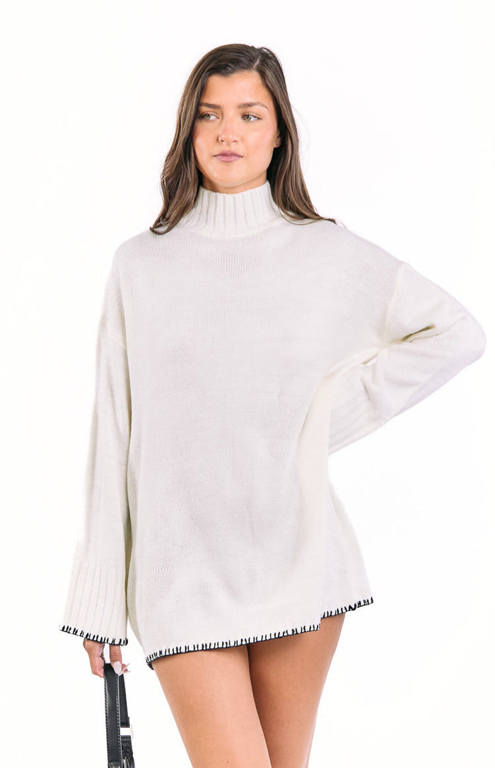 Beginning Boutique Flynn Cream Sweater Dress cream oversized knit mock neck sweater dress with long sleeves and black whipstitch trim