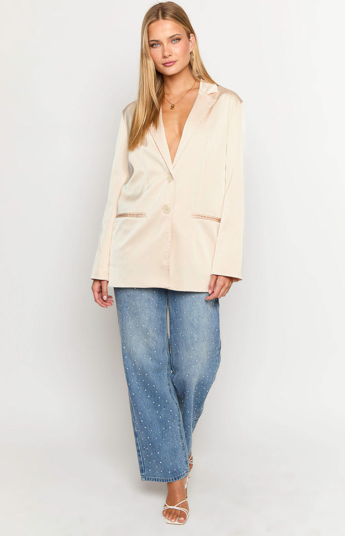 Relaxed cream satin blazer with a single button closure and contrasting trim on the flap pockets