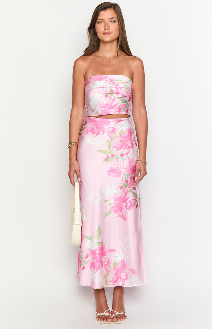 Front view of a pink floral print maxi skirt with a matching strapless crop top