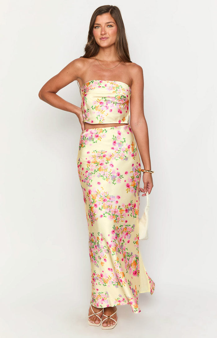 Flowing yellow maxi skirt with a vibrant pink and orange floral print