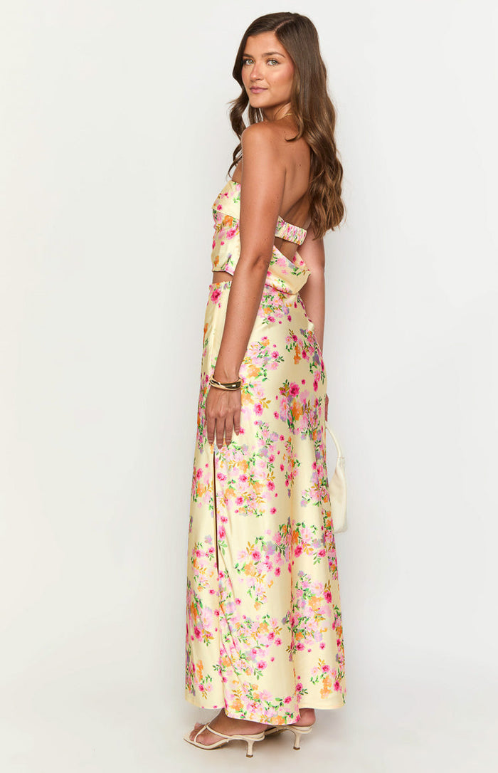 Side view of a yellow floral maxi skirt with a high side slit