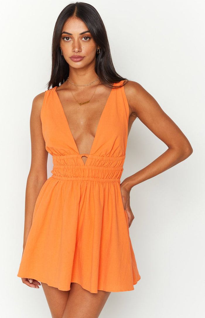 Orange crinkle mini dress with a deep V-neckline, shirred waist, and small cutout detail