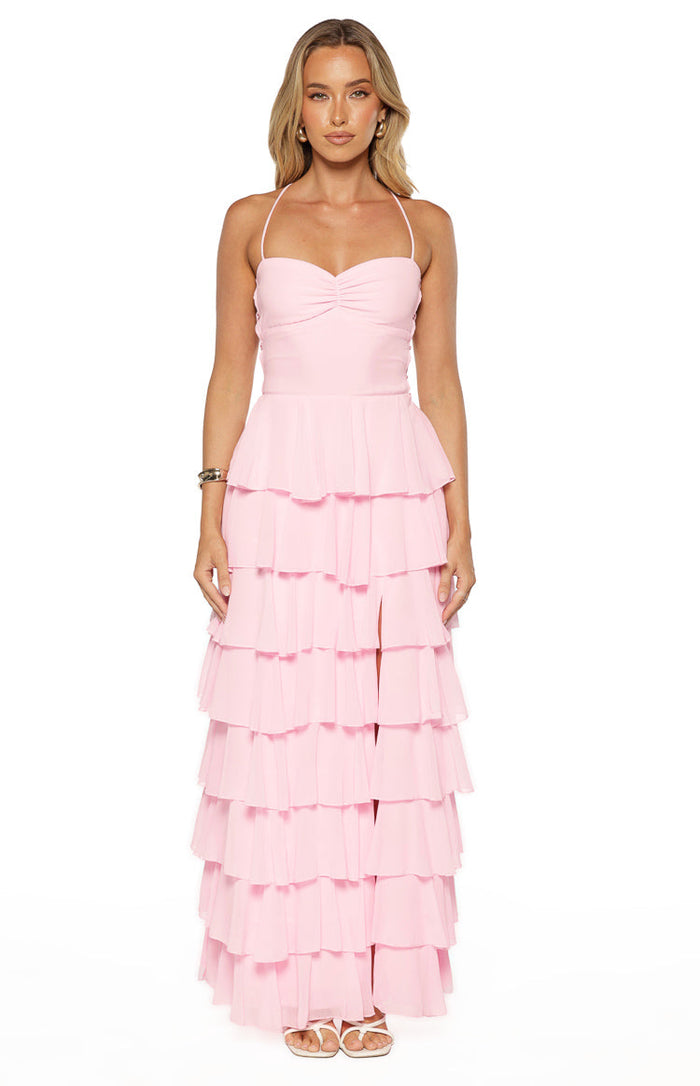Pink maxi dress with a ruched sweetheart bust, delicate halter straps, and a tiered ruffle skirt with a high leg slit