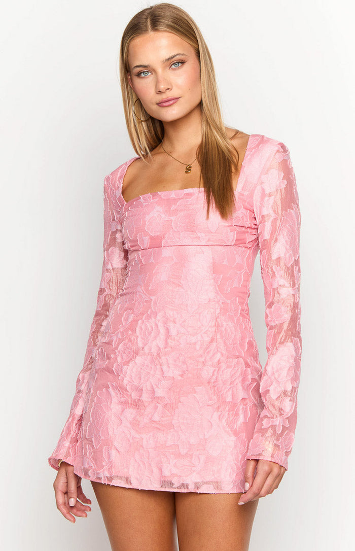 Close-up of the square neckline and textured pink floral fabric of a long sleeve mini dress