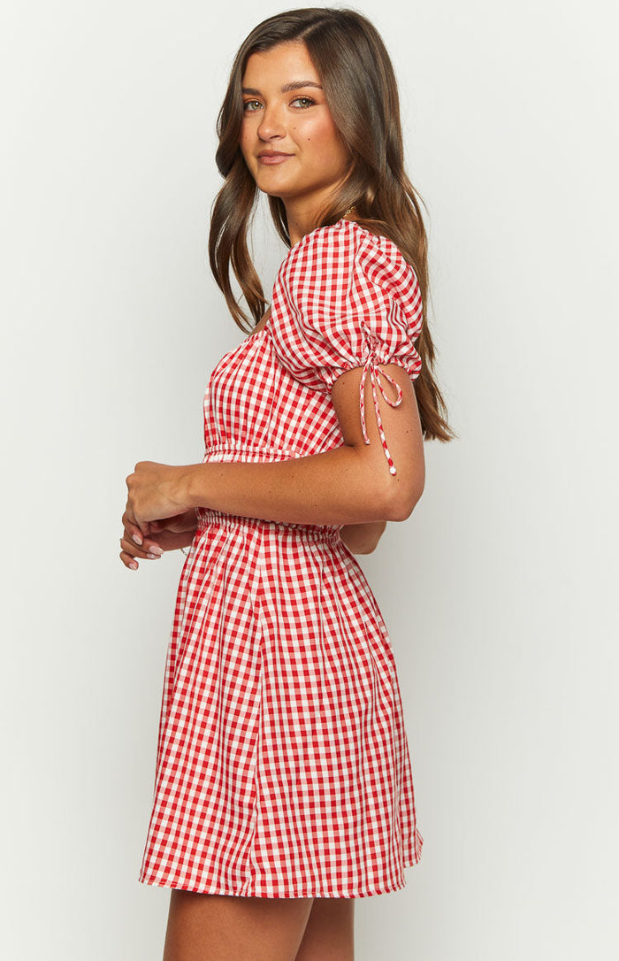 Side view of the red gingham mini dress showing puff sleeves with tie details and elasticated waist