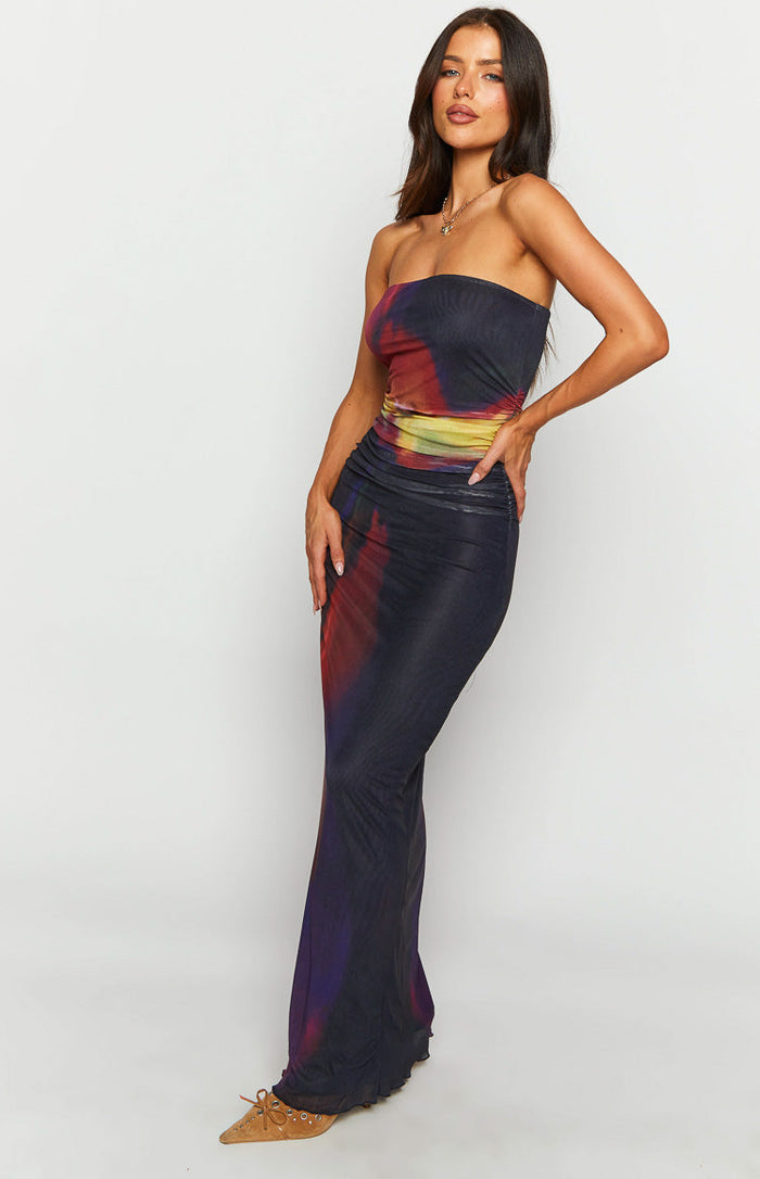Side view of the strapless black blurred tulip print maxi dress with a ruched waist and flowing skirt