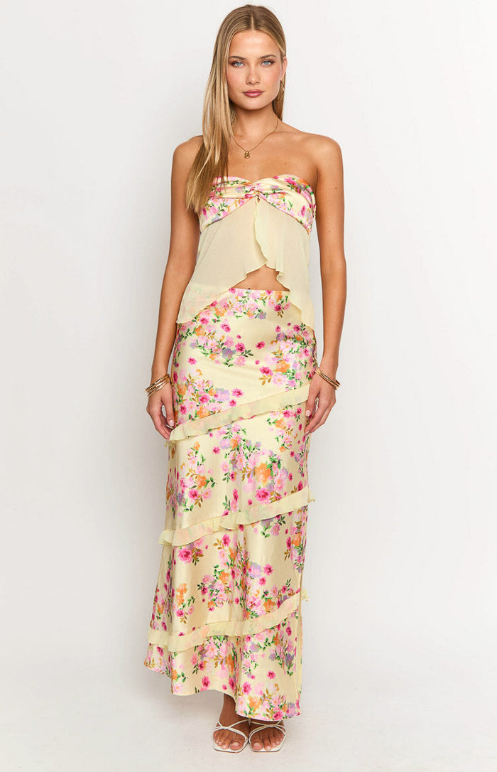 Yellow floral strapless top with a twisted bust and a sheer draped overlay with an asymmetrical hem