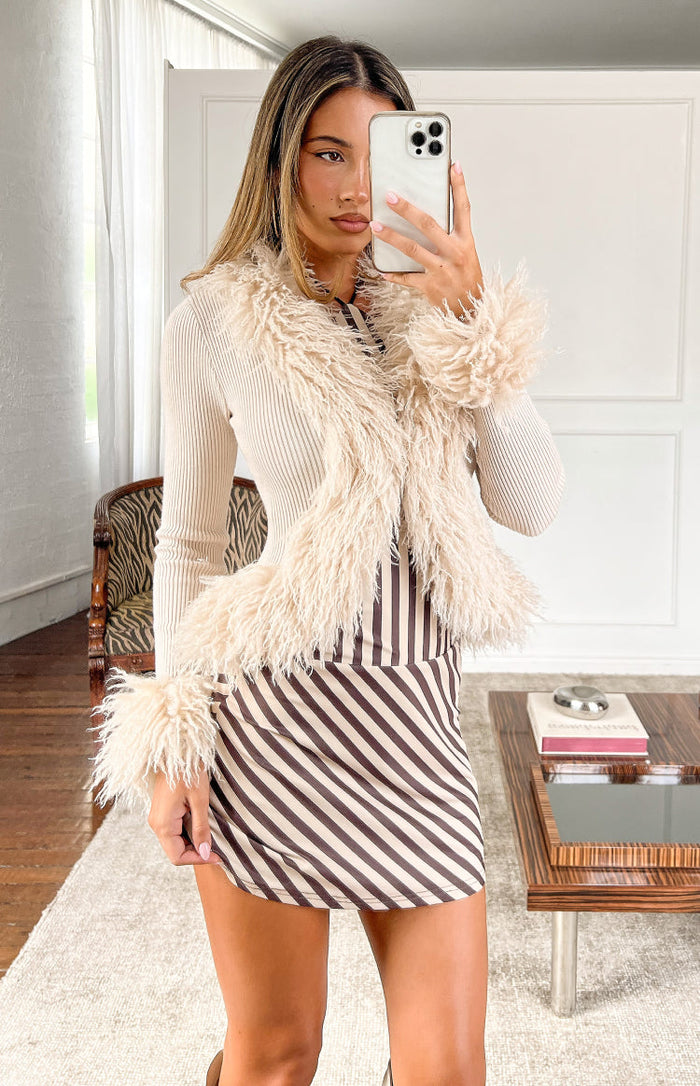 Brown and cream diagonal stripe mini dress with a fitted silhouette and short length