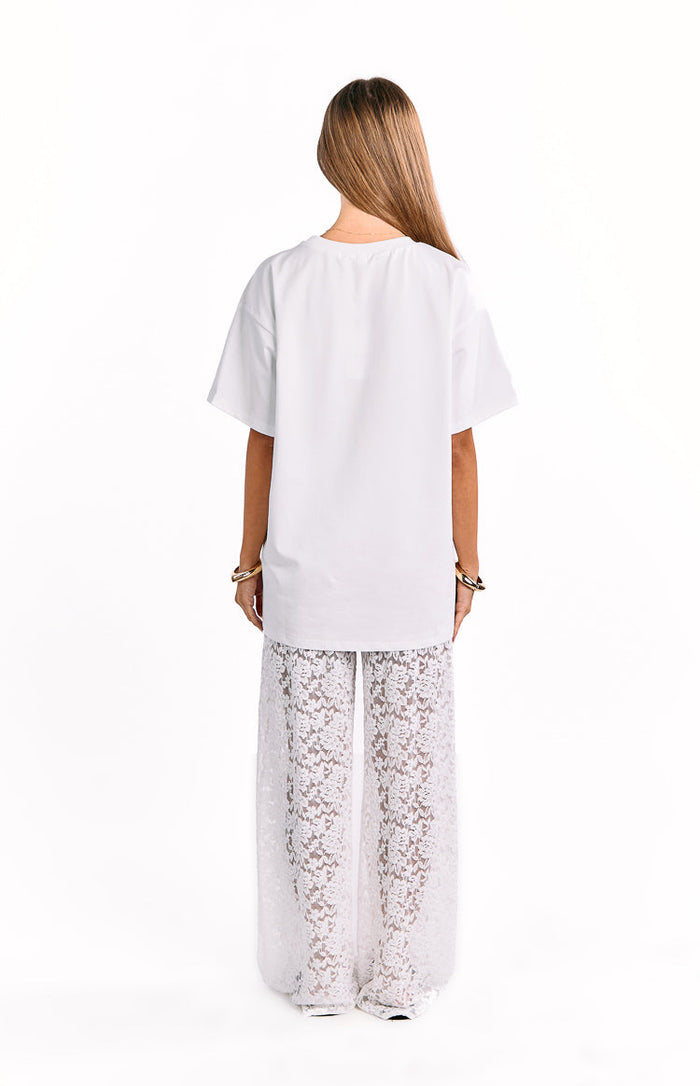 Rear view of white wide-leg pants with a floral lace pattern