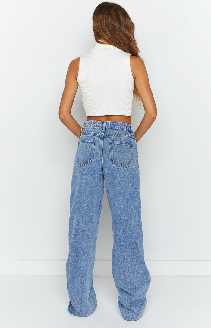 Rear view of light blue wide-leg jeans showing back pockets, belt loops, and a relaxed fit