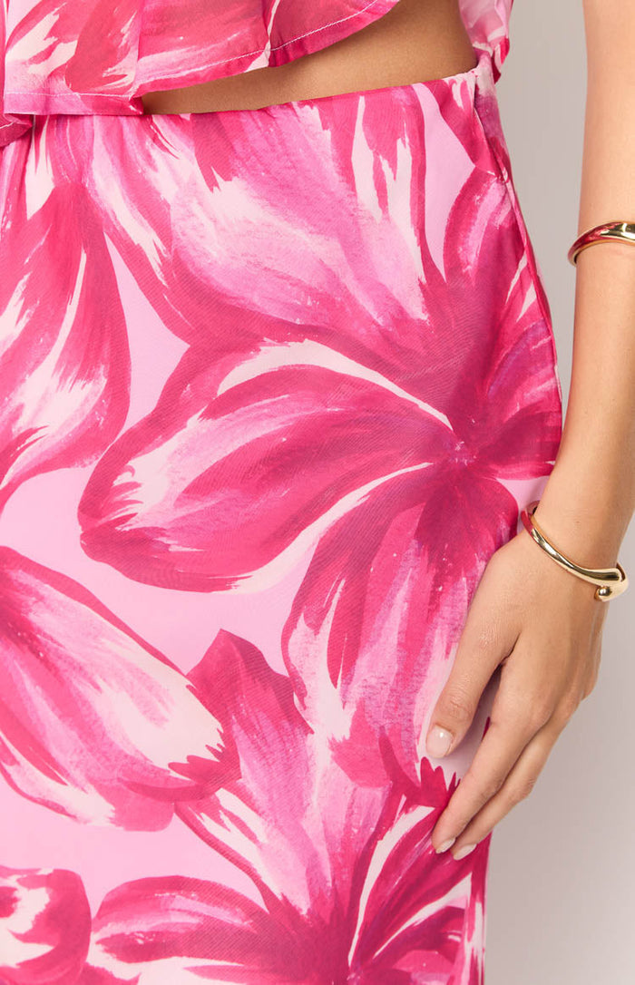 Close-up of the pink floral pattern with fuchsia and light pink brushstrokes on the flowy maxi skirt fabric