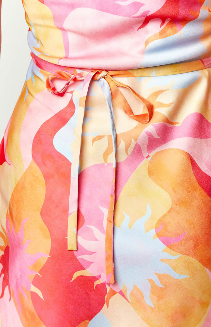 Close-up of the self-tie waist detail on the pink, orange, and blue sun print mini dress