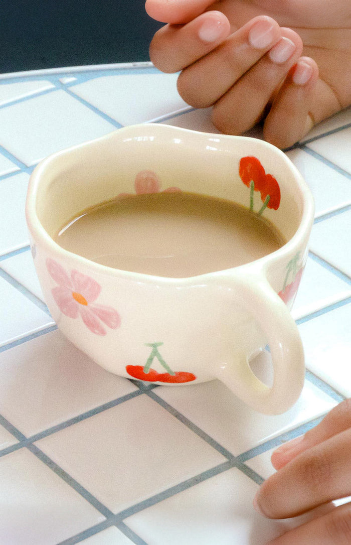 Beginning Boutique Lila Cherry Floral Mug cream ceramic mug with an organic shape and red cherry and pink floral pattern