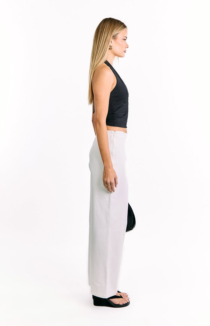 Side view of off-white wide-leg pants with a relaxed fit and smooth fabric
