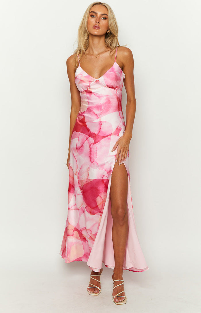 Pink satin maxi dress with a V-neck, spaghetti straps, watercolor print, and a high leg slit