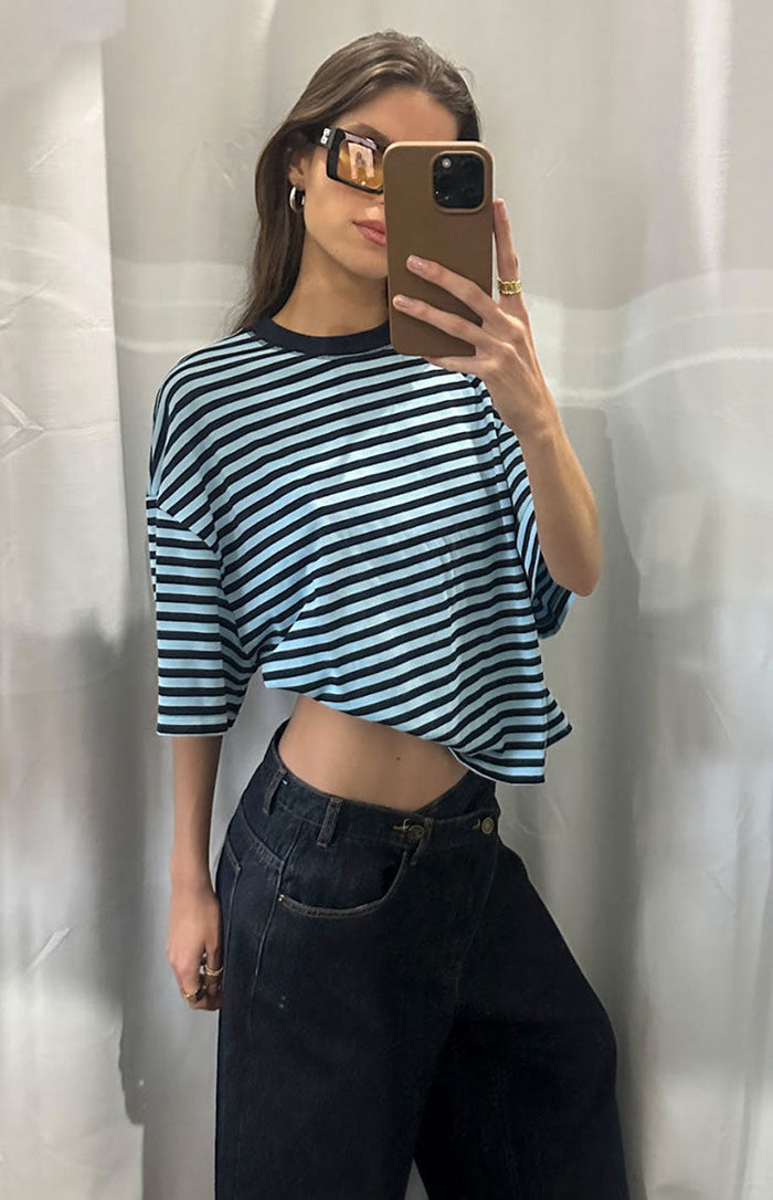 Cropped light blue and navy striped short sleeve top with a relaxed fit and elbow-length sleeves