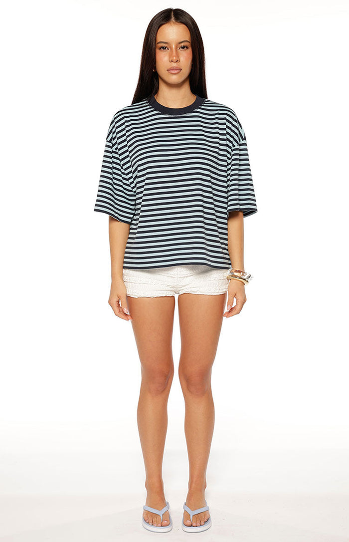 Front view of the oversized navy and light blue striped short sleeve top with a straight hem