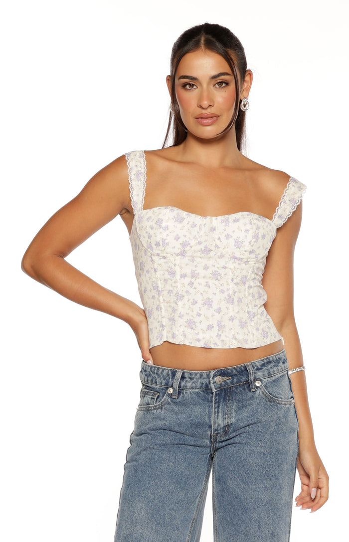 White corset top with purple floral print, sweetheart neckline, delicate lace trim on the shoulder straps