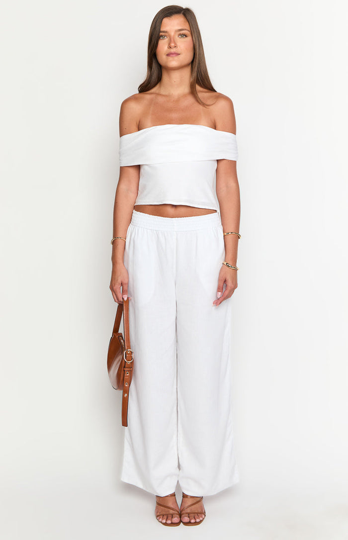 Front view of white linen blend wide-leg pants with an elasticated high waist and side pockets