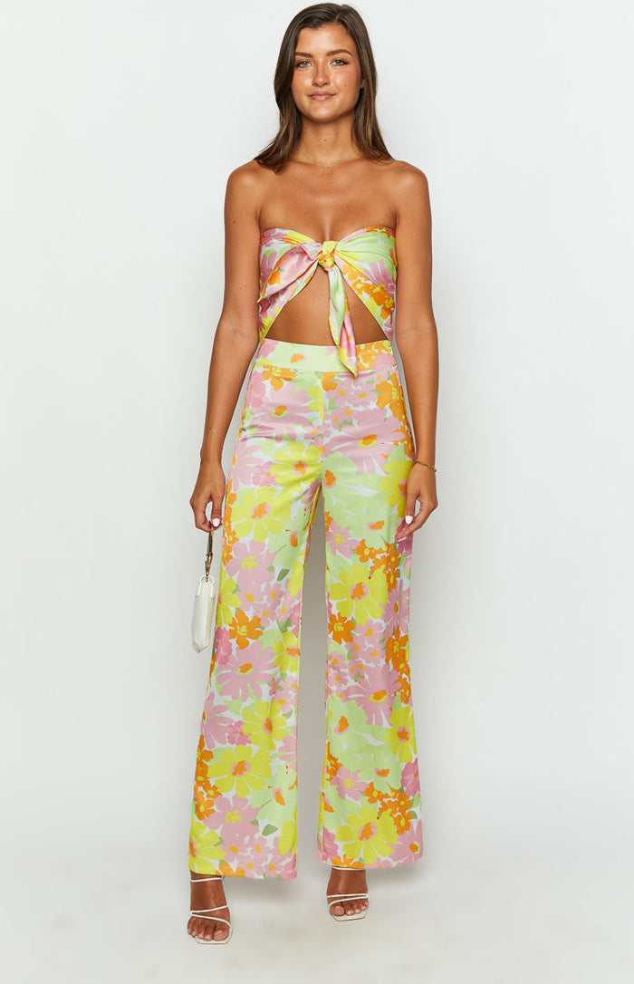 Front view of a yellow floral scarf top with a tie-front knot and cut-out detail