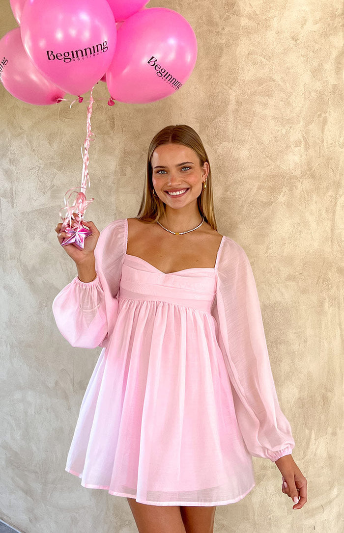 Beginning Boutique Narla Pink Long Sleeve Mini Dress pink sheer long sleeve mini dress with sweetheart neckline and gathered bust
