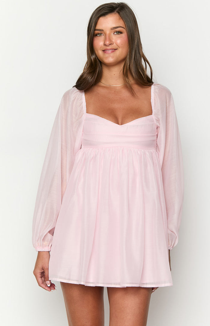 Pink mini dress with a sweetheart neckline, sheer voluminous long sleeves, and a gathered empire waist