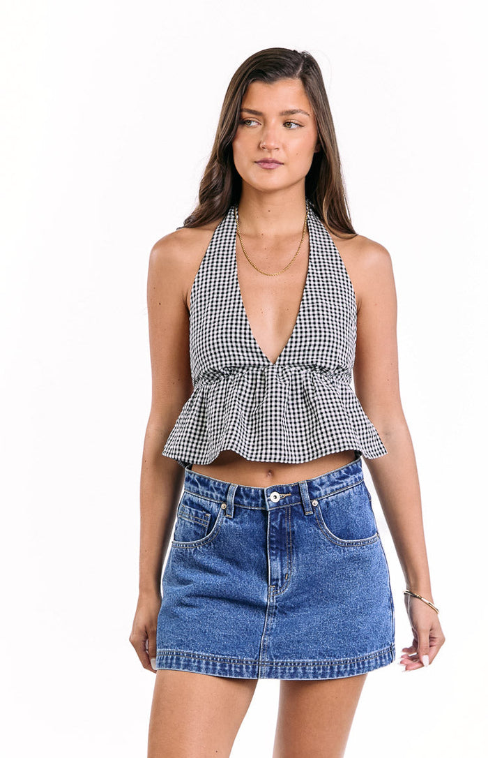 Black and white gingham crop top with a halter neckline, deep V-neck, and gathered peplum hem