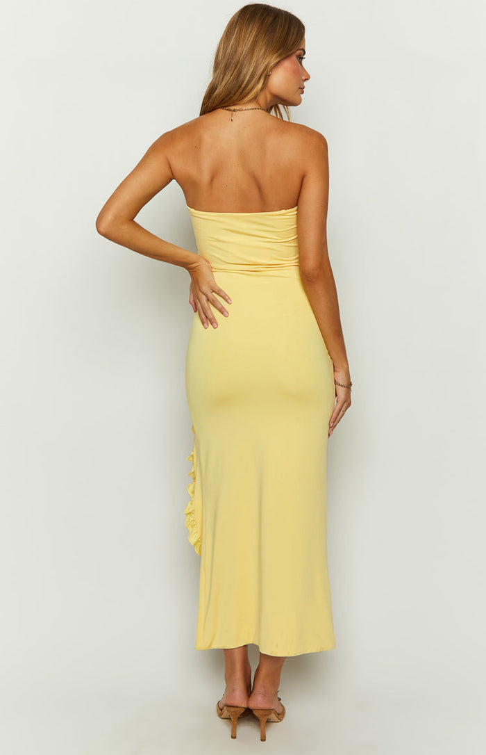Back view of the yellow strapless maxi dress with a fitted bodice and ruched side seam