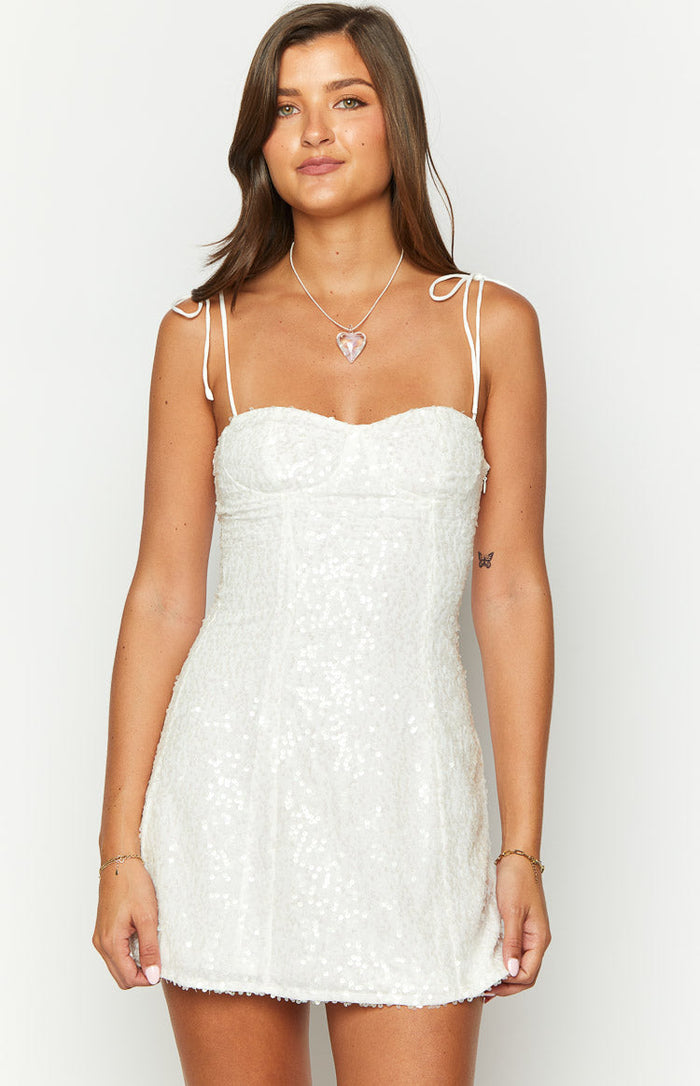 Front view of a white sequin mini dress with tie-up spaghetti straps and a sweetheart bustier neckline