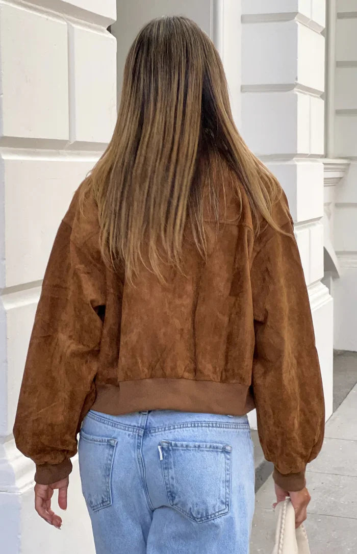 Rear view of a tan suedette bomber jacket with a ribbed hem and cuffs, showing the relaxed fit and voluminous sleeves