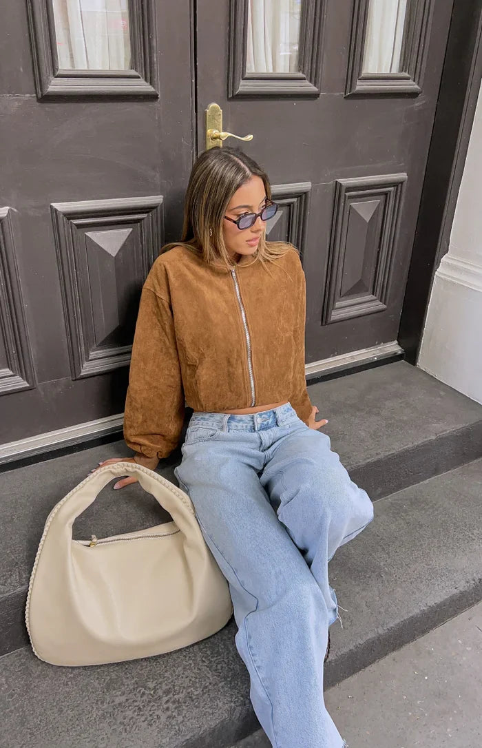 Cropped brown suedette bomber jacket with a silver front zipper and relaxed fit
