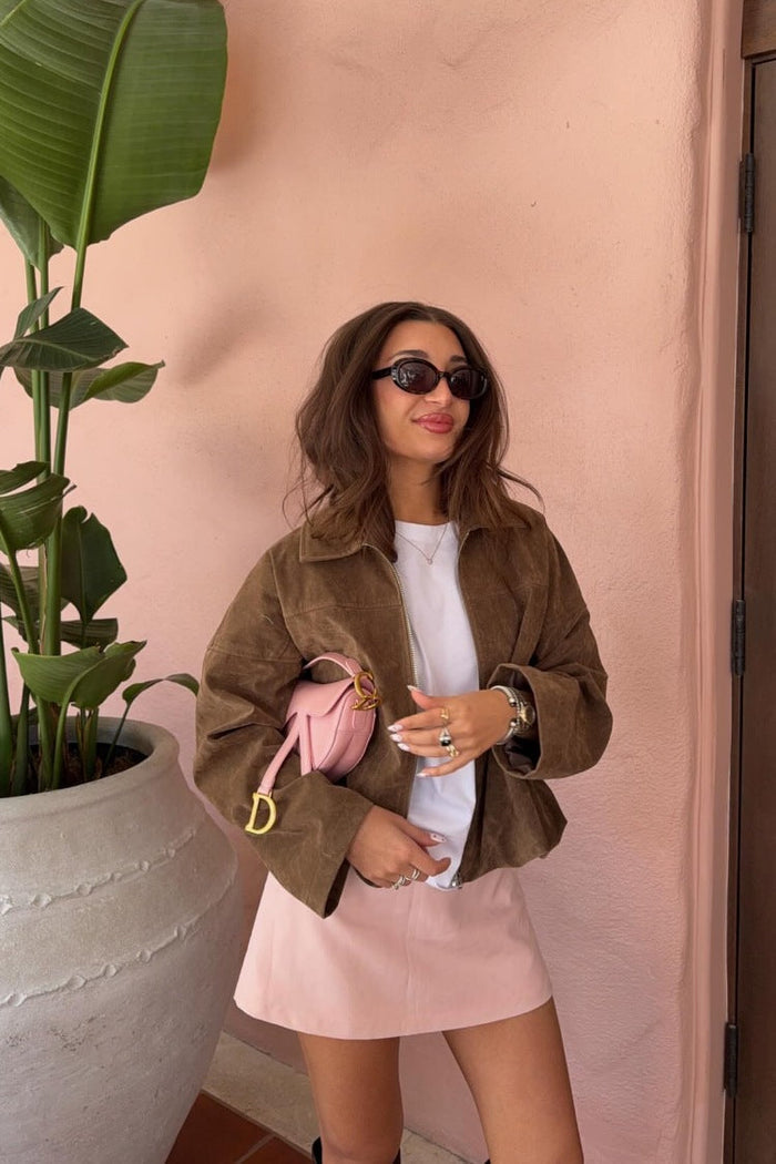 Front view of a brown suedette bomber jacket with a wide collar, long sleeves, and a gathered bubble hem