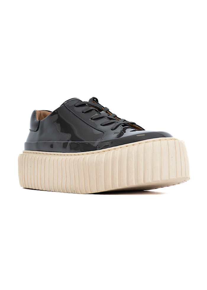 A picture of a washed Grey glossy patent leather Shoe. Showing the beige platform sole which adds height finished with a classic lace up.